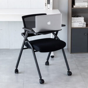 Folding training chair with writing desk for meetings and conferencesThis image shows a folding training chair with an attached writing desk. Ideal for office meetings, conferences, or training sessions, this versatile chair provides ergonomic support and space-saving functionality.

